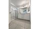 Bright bathroom featuring a double vanity, a large mirror, and a glass-enclosed shower at 7900 Wood Shadow Ct, Las Vegas, NV 89131