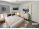 Staged bedroom featuring neutral walls, streamlined decor, and a queen-sized bed with side tables at 7900 Wood Shadow Ct, Las Vegas, NV 89131