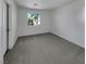 Bright bedroom features a window view of a palm tree, and neutral carpeting at 7900 Wood Shadow Ct, Las Vegas, NV 89131