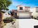 Two-story home with a front-facing two car garage and easy-to-maintain desert landscaping at 7900 Wood Shadow Ct, Las Vegas, NV 89131