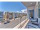 Balcony view showcasing neighborhood with chairs and metal railing, offering outdoor seating at 8076 Haywood Estate Ave, Las Vegas, NV 89113