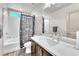 This bathroom has an extended vanity, a shower-tub combo with a decorative curtain, and light walls at 8076 Haywood Estate Ave, Las Vegas, NV 89113