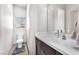 This bathroom features a single sink with a marble countertop and tiled floors and walls at 8076 Haywood Estate Ave, Las Vegas, NV 89113