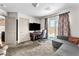 Comfortable bedroom features carpet, a large television, and sliding glass doors to an outdoor patio at 8076 Haywood Estate Ave, Las Vegas, NV 89113
