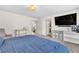 Bedroom featuring plush carpeting, a large bed, and an entertainment center, creating a serene and inviting atmosphere at 8076 Haywood Estate Ave, Las Vegas, NV 89113