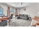 Spacious bedroom with a comfortable couch, office space, and a sliding glass door to the outside at 8076 Haywood Estate Ave, Las Vegas, NV 89113
