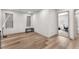 This bedroom has wood floors, a small bench, and large windows for natural light at 8076 Haywood Estate Ave, Las Vegas, NV 89113