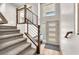 Bright foyer with stairs, modern railing, and a window providing natural light at 8076 Haywood Estate Ave, Las Vegas, NV 89113
