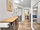 This hallway features hardwood floors, neutral-colored walls, and a series of doors at 8076 Haywood Estate Ave, Las Vegas, NV 89113