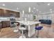 Modern kitchen with stainless steel appliances, an island with bar seating, and hardwood floors at 8076 Haywood Estate Ave, Las Vegas, NV 89113