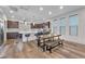 Large kitchen with island, stainless appliances, breakfast bar, and a dining table with benches at 8076 Haywood Estate Ave, Las Vegas, NV 89113