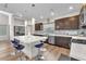Well-lit kitchen featuring stainless steel appliances, an island with seating, and plenty of counter space at 8076 Haywood Estate Ave, Las Vegas, NV 89113