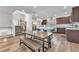 Bright kitchen featuring stainless steel appliances, a center island, and an adjacent dining area with wood floors at 8076 Haywood Estate Ave, Las Vegas, NV 89113