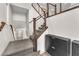 Modern staircase with wooden handrail and metal balusters leading to the upper level of the home at 8076 Haywood Estate Ave, Las Vegas, NV 89113
