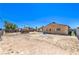 Wide shot of the spacious dirt backyard with chain-link fence, a small shed, and a small blue pool at 844 Balzar Ave, Las Vegas, NV 89106