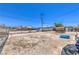 Dirt backyard featuring chain-link fencing, a small shed and a small blue pool at 844 Balzar Ave, Las Vegas, NV 89106