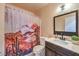 Bathroom with a shower featuring a decorative curtain, toilet, vanity with sink and mirror at 844 Balzar Ave, Las Vegas, NV 89106