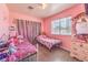 Pink bedroom featuring two twin beds, a window with blinds, and a dresser with decorative items at 844 Balzar Ave, Las Vegas, NV 89106