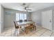 Bright dining area featuring tile floors, a ceiling fan, and a table, adjacent to a white door at 844 Balzar Ave, Las Vegas, NV 89106