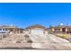 Charming single-story home with a concrete driveway, fenced yard, and a two-car garage in a residential neighborhood at 844 Balzar Ave, Las Vegas, NV 89106