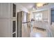 Well-lit kitchen featuring stainless steel fridge and ample cabinet space at 844 Balzar Ave, Las Vegas, NV 89106