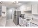 Updated kitchen with stainless steel refrigerator and white cabinetry at 844 Balzar Ave, Las Vegas, NV 89106