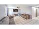 Open-concept living room featuring tile floors, and a cozy seating area with a TV and furniture at 844 Balzar Ave, Las Vegas, NV 89106