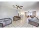 Spacious living room featuring tile floors, ceiling fan, and open to a dining area and kitchen at 844 Balzar Ave, Las Vegas, NV 89106