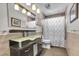 Stylish bathroom featuring modern vanity, decorative mirror, and tiled walls at 9417 Grenville Ave, Las Vegas, NV 89134