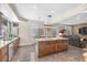 Open-concept kitchen with an island, stone countertops, and barstool seating at 9417 Grenville Ave, Las Vegas, NV 89134