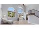 Bright living room with high ceilings, tile flooring, and natural light and access to the pool at 9417 Grenville Ave, Las Vegas, NV 89134