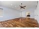Bright main bedroom with hardwood floors, vaulted ceilings, recessed lighting, and arched doorway to bathroom at 9417 Grenville Ave, Las Vegas, NV 89134