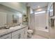 Bright bathroom with granite countertops, a large mirror, and a clean, well-maintained shower-tub combination at 1044 Forest Falcon Dr, Henderson, NV 89011