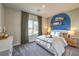 Bright bedroom with ample natural light, a queen-sized bed, and decorative shelves with a splash of color at 1044 Forest Falcon Dr, Henderson, NV 89011