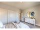 Cozy bedroom with a modern dresser, stylish oval mirror, and a well-lit closet for ample storage space at 1044 Forest Falcon Dr, Henderson, NV 89011
