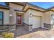 Close up of the home's front entrance and garage, with brick driveway at 1044 Forest Falcon Dr, Henderson, NV 89011