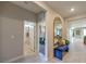 Hallway with bench seat that opens to a bathroom, office, and living space at 1044 Forest Falcon Dr, Henderson, NV 89011