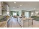 Well-equipped kitchen with stainless steel appliances, center island, open to dining and living areas at 1044 Forest Falcon Dr, Henderson, NV 89011