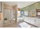 Bright bathroom features tiled floors, shower, and soaking tub with natural light at 1044 Forest Falcon Dr, Henderson, NV 89011