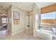 Bright bathroom features tiled floors, shower, and soaking tub with natural light at 1044 Forest Falcon Dr, Henderson, NV 89011