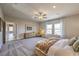 Comfortable main bedroom with carpet, fan, and natural light from three windows at 1044 Forest Falcon Dr, Henderson, NV 89011