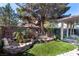 Tranquil backyard features mature trees, lush landscaping, and a charming stone fountain at 1409 Basin Brook Dr, North Las Vegas, NV 89032