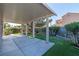Large covered patio, green lawn and landscaped garden beds offer serene outdoor living at 1409 Basin Brook Dr, North Las Vegas, NV 89032