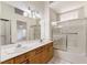 Bathroom with a double sink vanity, glass shower door, and white tile flooring at 1409 Basin Brook Dr, North Las Vegas, NV 89032