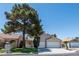 Charming single-story home with a well-maintained front yard and mature shade tree at 1409 Basin Brook Dr, North Las Vegas, NV 89032
