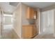 Hallway with carpet flooring and a built-in cabinet for convenient storage at 1409 Basin Brook Dr, North Las Vegas, NV 89032