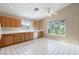 Bright kitchen with wood cabinets, white appliances, tile floors, and natural light at 1409 Basin Brook Dr, North Las Vegas, NV 89032