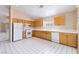 Functional kitchen with ample counter space, white appliances, and tile flooring provides an efficient cooking area at 1409 Basin Brook Dr, North Las Vegas, NV 89032