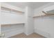 Walk-in closet with wood shelves, rails, and wire shoe rack for optimal storage at 1409 Basin Brook Dr, North Las Vegas, NV 89032
