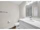Bright bathroom features a modern white vanity with a marble countertop and a decorative framed mirror at 1832 N Decatur Blvd # 104, Las Vegas, NV 89108